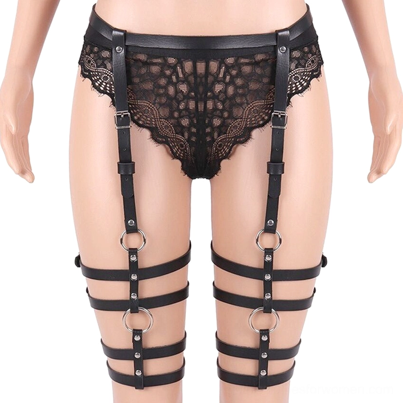 Black leather leg harness styled with lace underwear and black fishnet stockings gothic fashion look