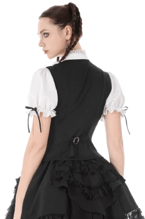 Back view of black and white gothic lolita blouse set showing adjustable buckle closure and ruffled stand collar on model