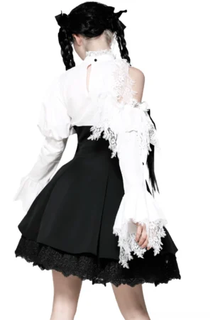 Back view of black white gothic lolita dress showing keyhole cutout and ruffled neckline with lace off-shoulder details