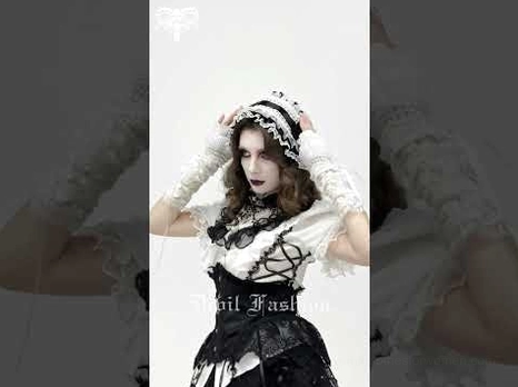 Female model wearing complete gothic lolita coordinate with lace bonnet, corset dress, and Victorian styling