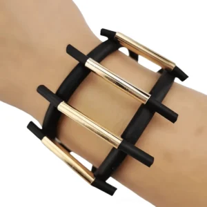 Black gothic magnetic wide bracelet with gold ladder pattern worn on wrist, showing geometric design from side angle