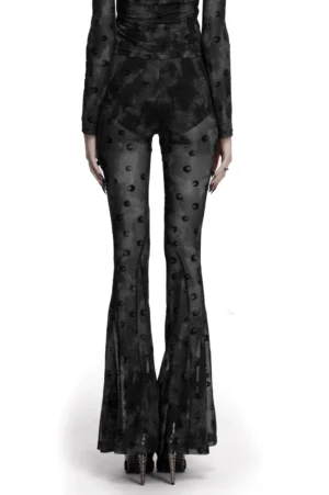 Rear view of crescent moon mesh gothic pants on model showing flared leg and flowing silhouette against white background