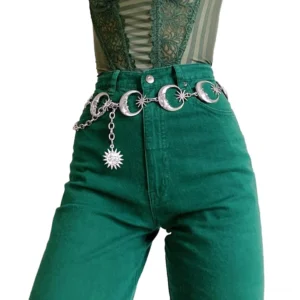 Vintage metal waist chain belt with crescent moon and star details displayed on model at front waist angle
