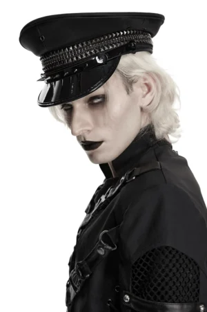 Punk military captain cap with metal studs and patent leather visor, side profile view on goth model