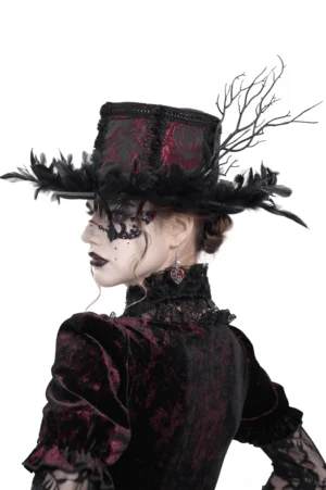 Gothic mini top hat with black feathers side back view, showing feather brim and burgundy rose fabric detail on model