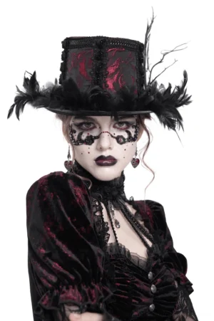 Black burgundy rose brocade gothic mini top hat with feather trim worn by model, front view showing detailed lace and satin rose embellishments