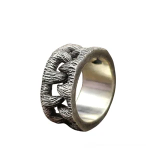Gothic monster teeth ring side angle perspective, antique chain-woven texture detail, stainless steel band with weathered patina finish