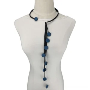 Navy blue round matte pendant tassel necklace on black rubber cord displayed on female torso mannequin