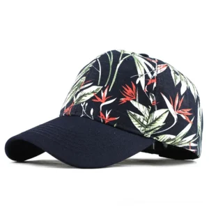 Dark navy gothic floral baseball cap with tropical flower print on crown, side front view showcasing botanical design