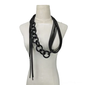 Handmade black gothic necklace featuring asymmetrical layered design with mixed chain and tassel elements on mannequin