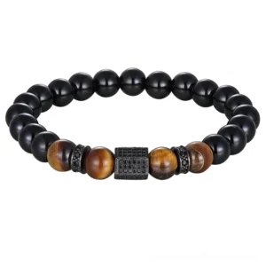 Black matte onyx and tiger eye cubic zirconia beaded bracelet with steel tone charm, gothic style jewelry for men, flat lay view
