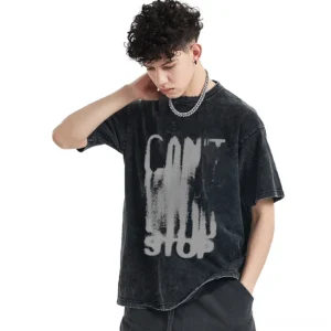 Male model wearing oversized black cotton gothic graphic tee with faded CAN'T STOP print, three-quarter side view showing relaxed unisex fit and distressed vintage aesthetic