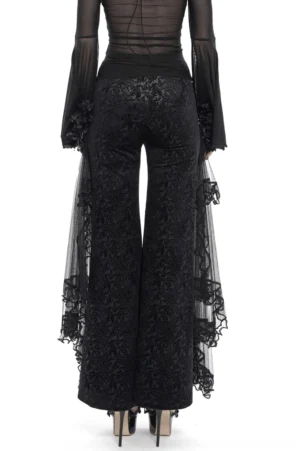 Black gothic palazzo trousers rear view showing sheer mesh train and flocked velvet texture detail