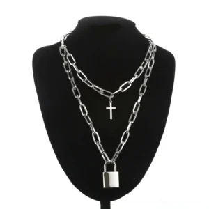 Paperclip-style gothic chain necklace featuring decorative lock and cross charms on mannequin display