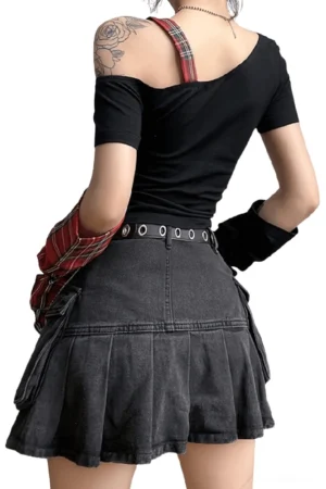 Back view of gothic one-shoulder patchwork crop top with adjustable plaid shoulder strap and metal buckle details, styled with pleated denim skirt