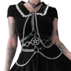 Pentagram chain harness worn with black ruffle collar dress on tattooed model demonstrating gothic styling