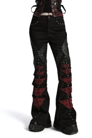 Gothic plaid flared pants with studs and mesh panels front side view on model