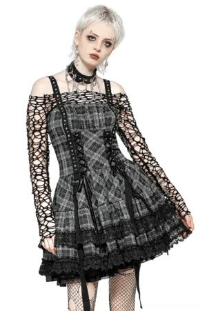 Gothic plaid corset mini dress with harness straps, front view on model with blonde punk hair and fishnet sleeves