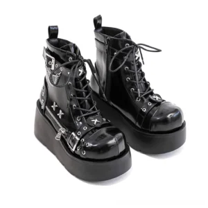 Black patent leather platform ankle boots with chain buckle details - side view showing wedge heel and lace-up front