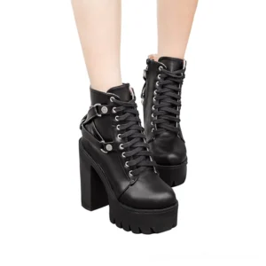 Model wearing black gothic platform ankle boots side low-angle view - harness buckles and thick lug sole tread visible