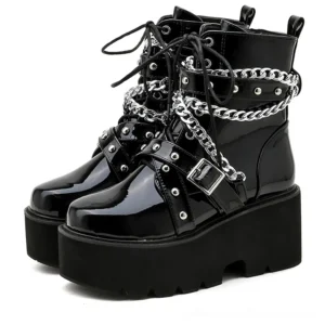 Black gothic platform combat boots with silver chain and rivet details, front view showcasing patent leather finish and square heel