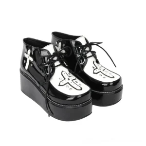 Black patent leather gothic platform lace-up shoes with cross rivets and wedge sole, three-quarter side view showing pair