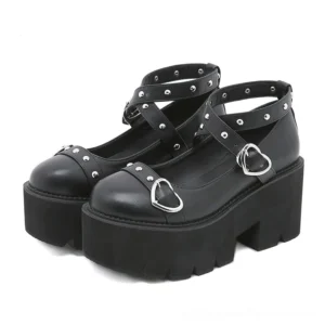 Black gothic platform Mary Janes with heart buckle and studded ankle straps, front three-quarter view