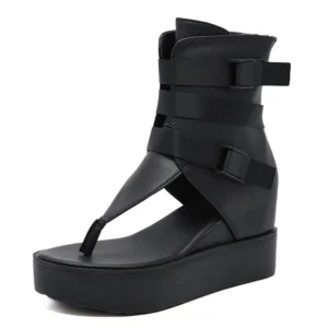 Single black gothic platform sandal, right side three-quarter view displaying adjustable buckle straps and thong gladiator toe construction