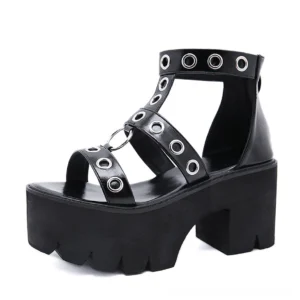Single black gothic platform sandal from front-three-quarter angle, displaying rivet details and thick textured sole
