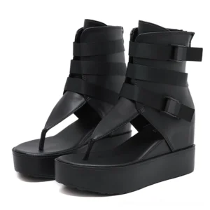 Black gothic platform sandals with multiple buckle straps and rear zipper, front paired view showing thong toe design and industrial hardware details