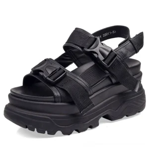 Black gothic platform sandals with adjustable buckle straps and chunky lug sole, top-front view