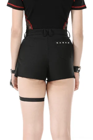Black gothic shorts rear view featuring studded back pocket and raw hem detail