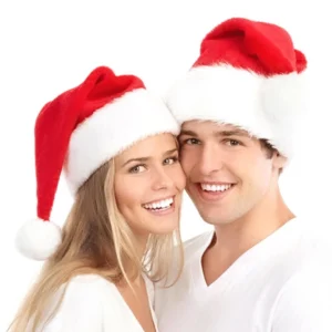 Couple wearing matching dark red plush Santa hats with white fuzzy trim and pom-poms, gothic festive holiday headwear for alternative Christmas celebration