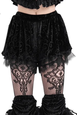 Black velvet puff shorts with baroque lace trim front view on model with fishnet stockings