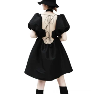 Black gothic puff sleeve mini dress with lace-up open back cutout, rear full-body view on model