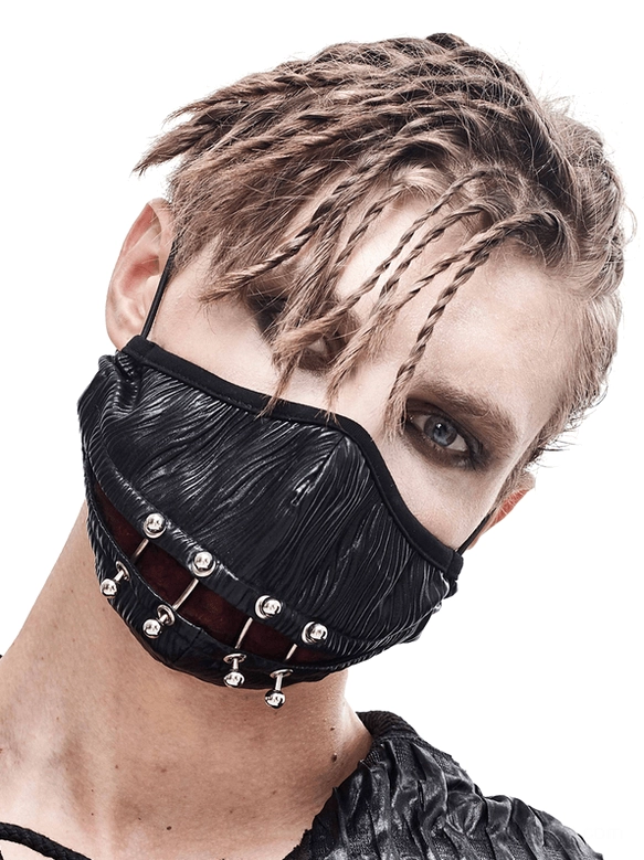 Black gothic punk face mask with metal piercing rings worn by male model with braided hair, front three-quarter view showcasing wrinkled faux leather and industrial cyberpunk aesthetic