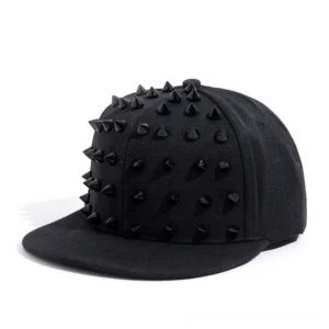 All-black studded snapback cap with black metal cone spikes, front three-quarter view