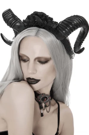 Black ram horn gothic headdress with lace and roses worn by model with silver hair, front three-quarter view studio photography