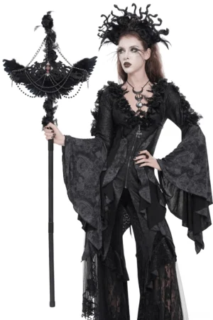 Gothic raven cross staff with roses and beaded chains worn by female model in dark theatrical outfit, three-quarter left side view