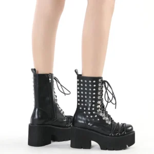 Women's black rivet platform motorcycle boots with lace-up and side zipper, shown on model's legs from front double view