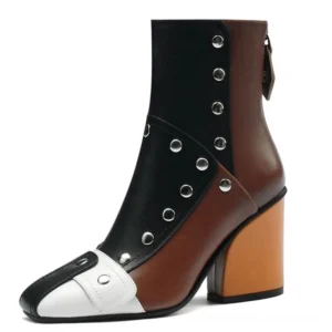 Gothic riveted multicolor leather ankle boots with metal studs and back zipper, studio front view