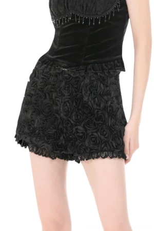 Gothic black rose textured shorts with 3D appliqué and ruffled lace hem from front side angle