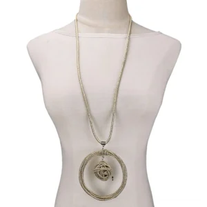 Champagne gold gothic round pendant necklace with braided metal chain and twisted ball pendant on mannequin torso
