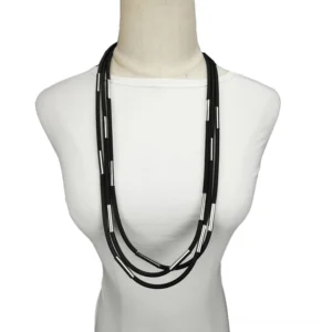 Layered black rubber gothic necklace with silver metal accents displayed on female mannequin, front view