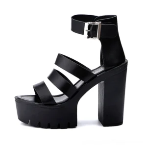 Single black platform block heel sandal side view showing lugged rubber sole and architectural heel structure for gothic aesthetic
