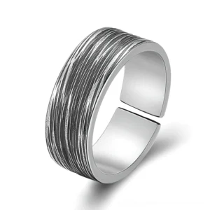 Gothic adjustable open textured sterling silver ring with vertical brushed grain finish, front close-up view on white background