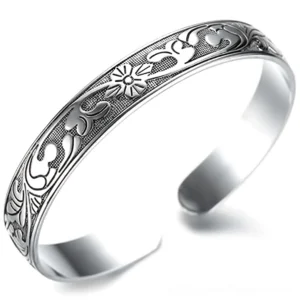 Gothic silver ethnic floral open cuff bracelet front view, vintage hand-engraved bangle with ornate flower patterns on white background