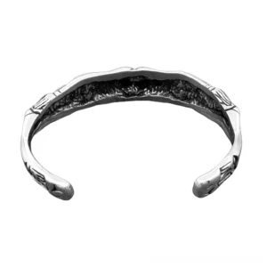 open-ended gothic skeleton bracelet front view showing dual skull embossed design stainless steel