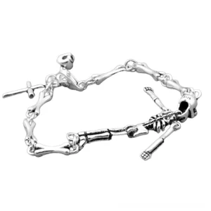 Side oblique angle view of unisex skeleton punk bracelet displaying dual skeleton accents, cross charm, and toggle clasp mechanism in oxidized silver