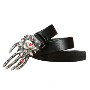 Detailed view of carved skull hand buckle with silver metal finish and red heart gem decoration on gothic leather belt